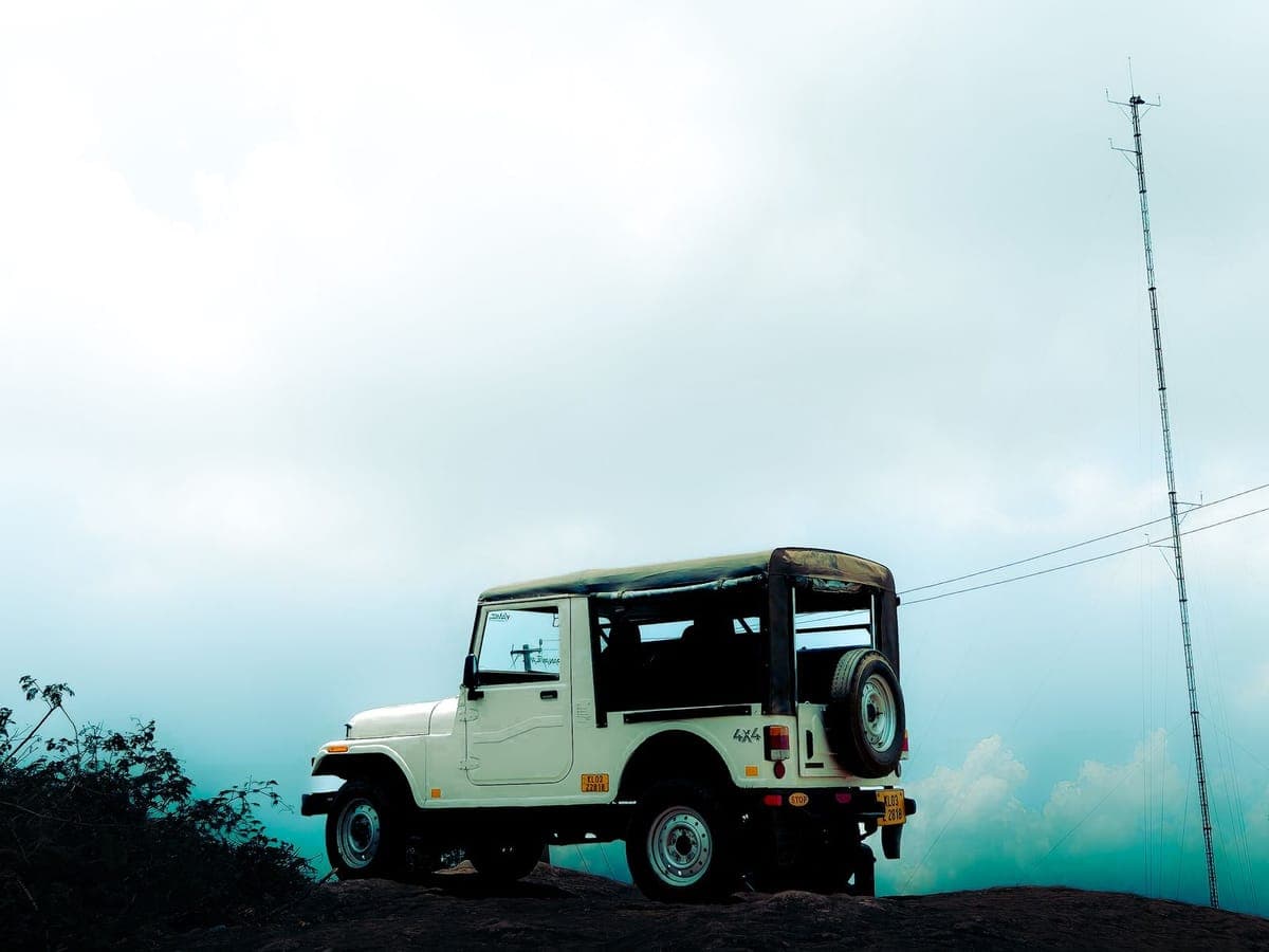 Classic 4x4 jeep at sunrise over Mount Batur volcano