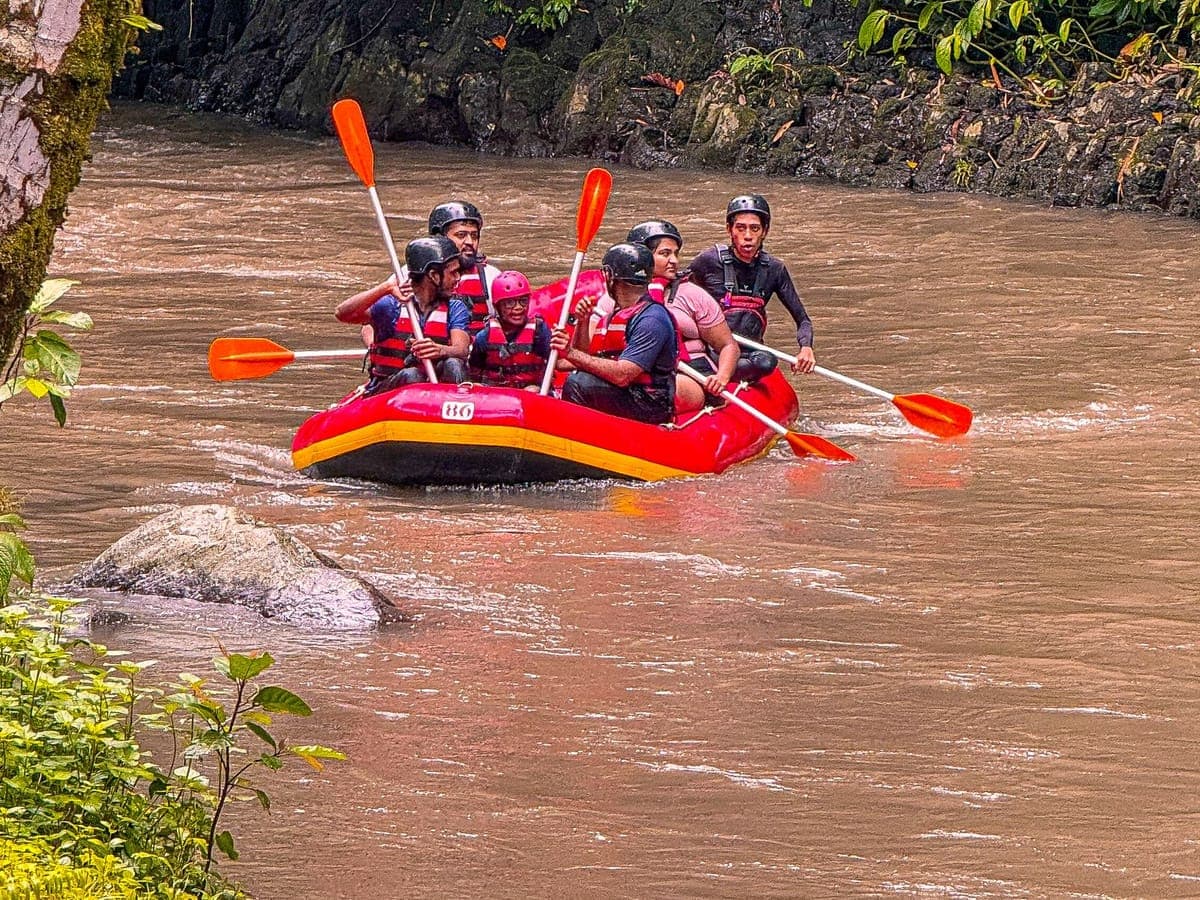 Raft splashing through a rapid on the Ayung river in Bali
