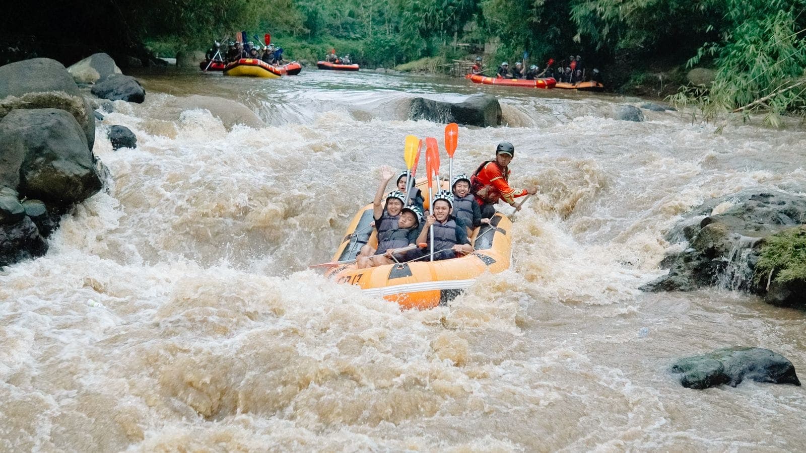 Raft splashing through a rapid on the Ayung river in Bali