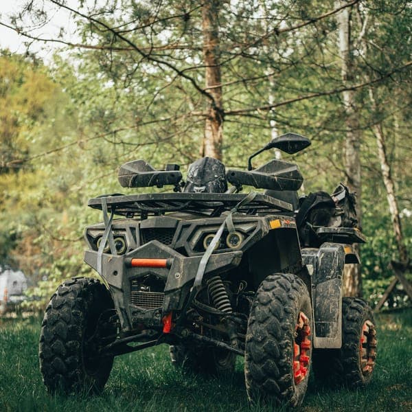 Guests riding ATV quad bikes through a Bali jungle trail