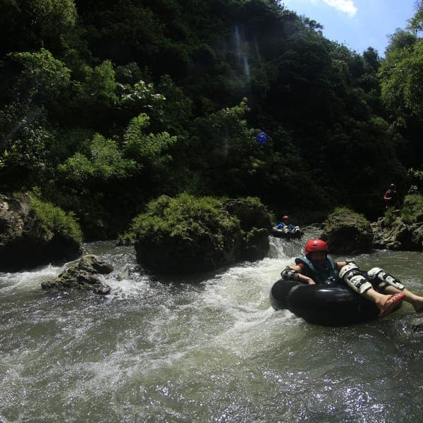 River tubing through a lush green gorge