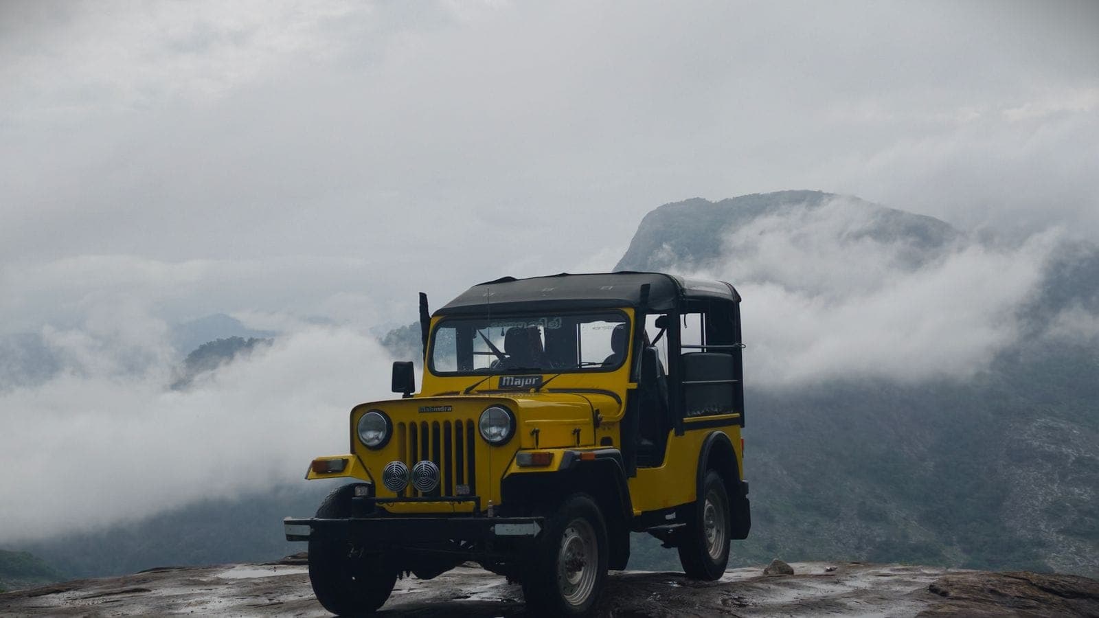 Classic 4x4 jeep at sunrise over Mount Batur volcano